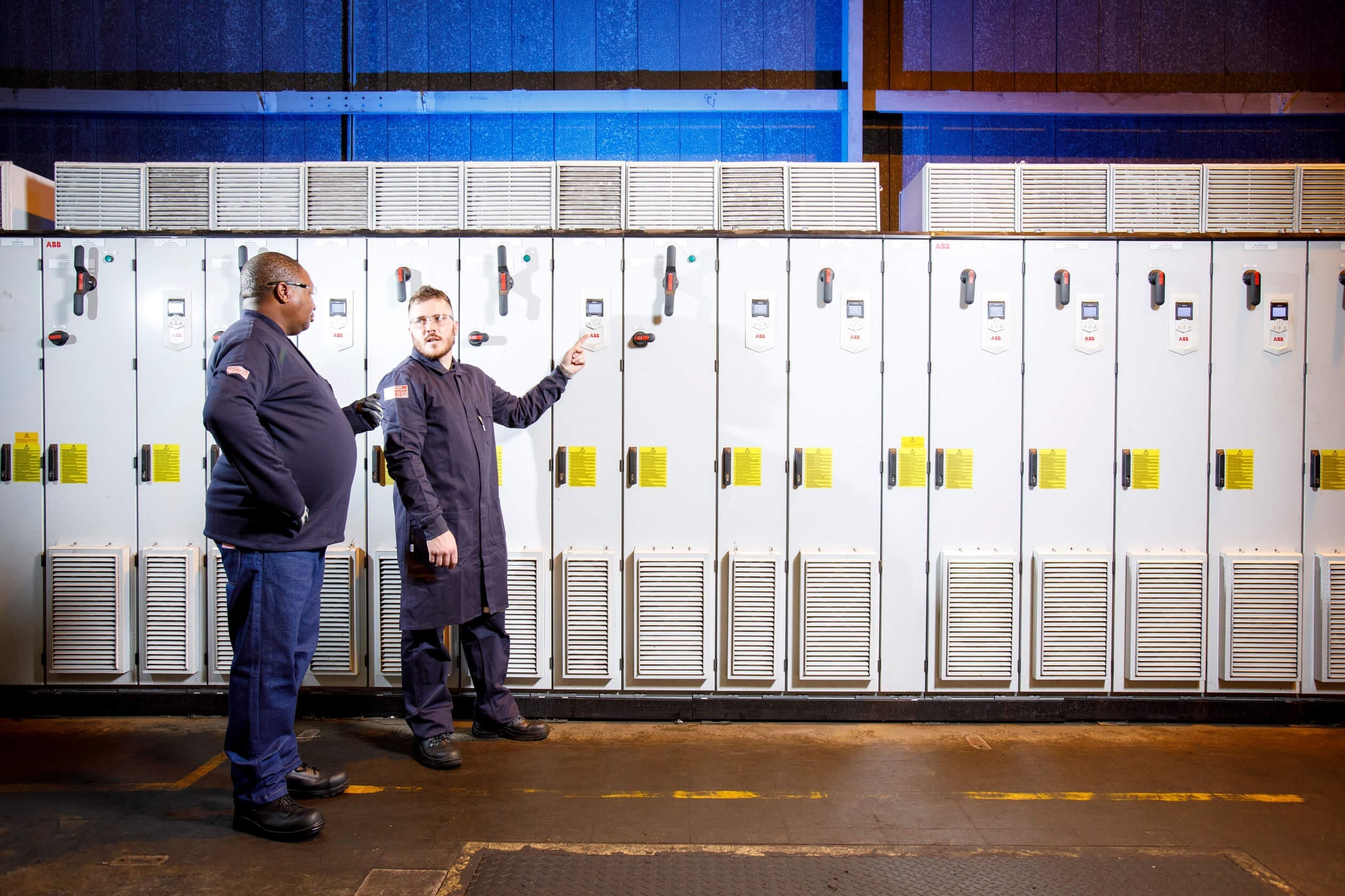 two men standing wearing SURVIVE-ARC® dust coats
